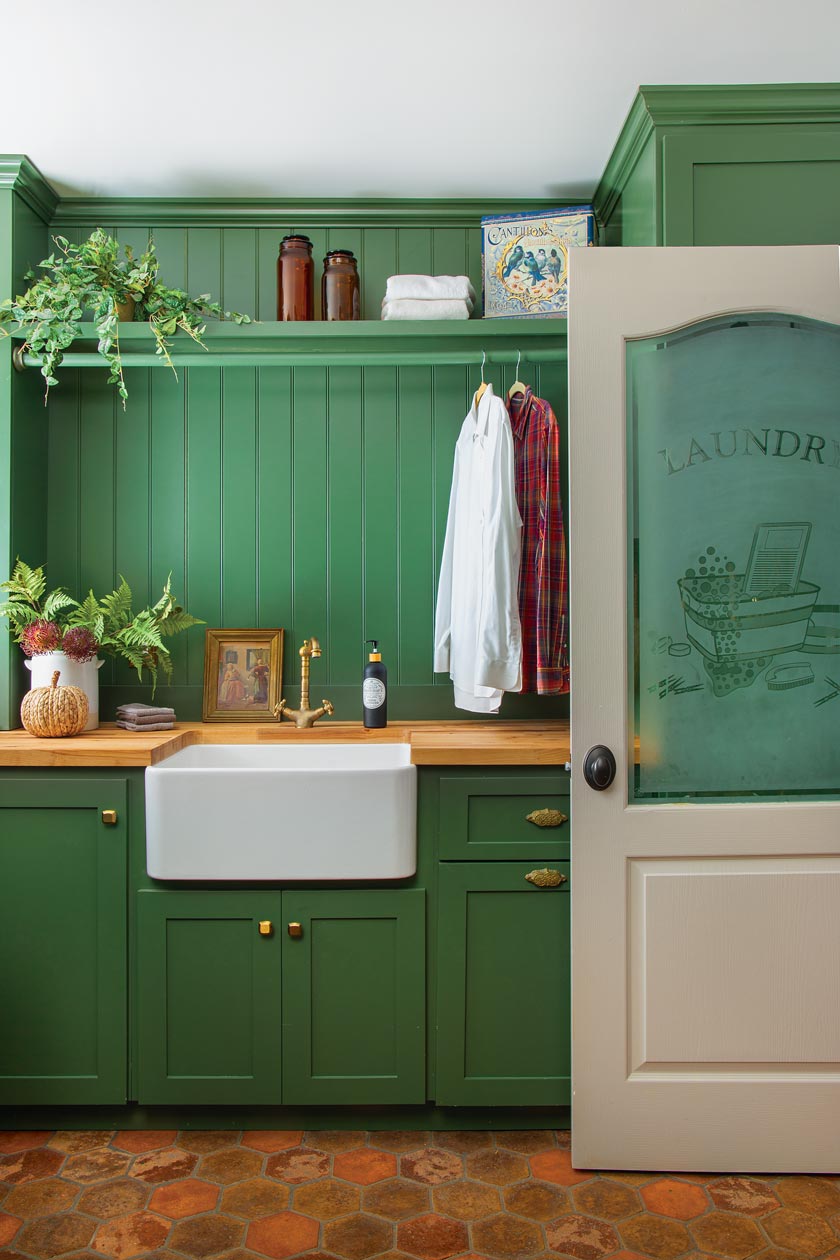 green beadboard and cabinetry in laundry room