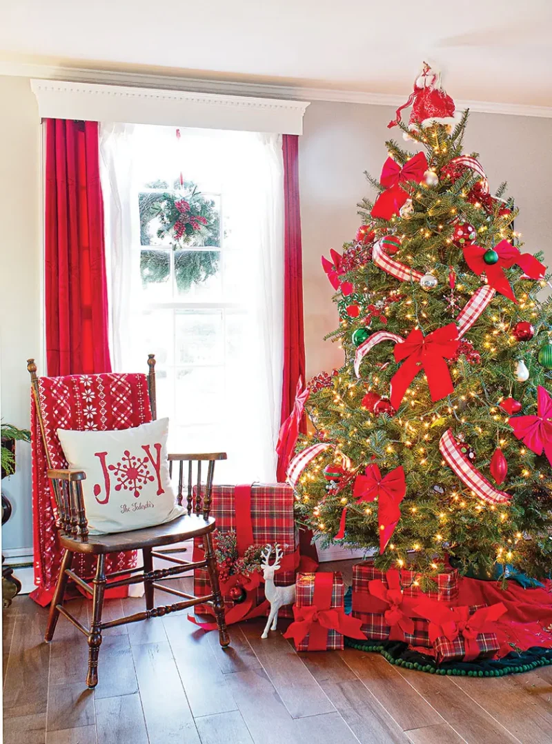 red ribbons on tree in room with red curtains and red throw