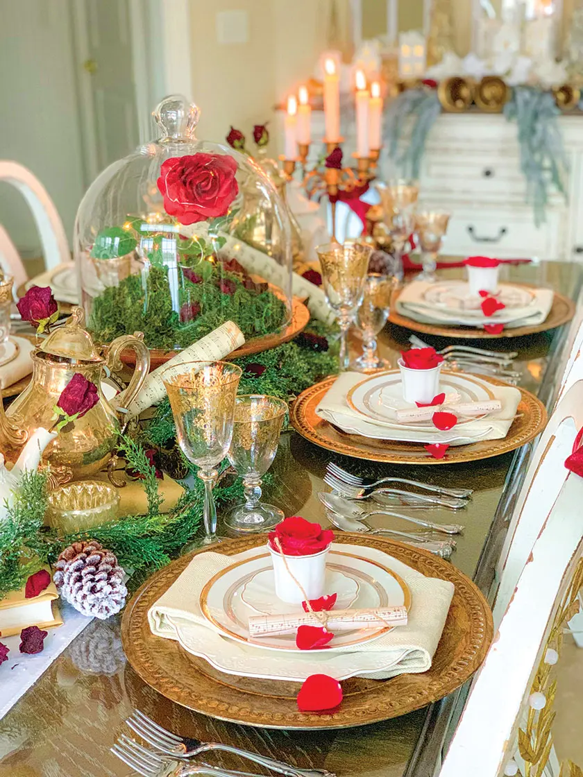 red roses on white and gold place settings for red Christmas tablescape
