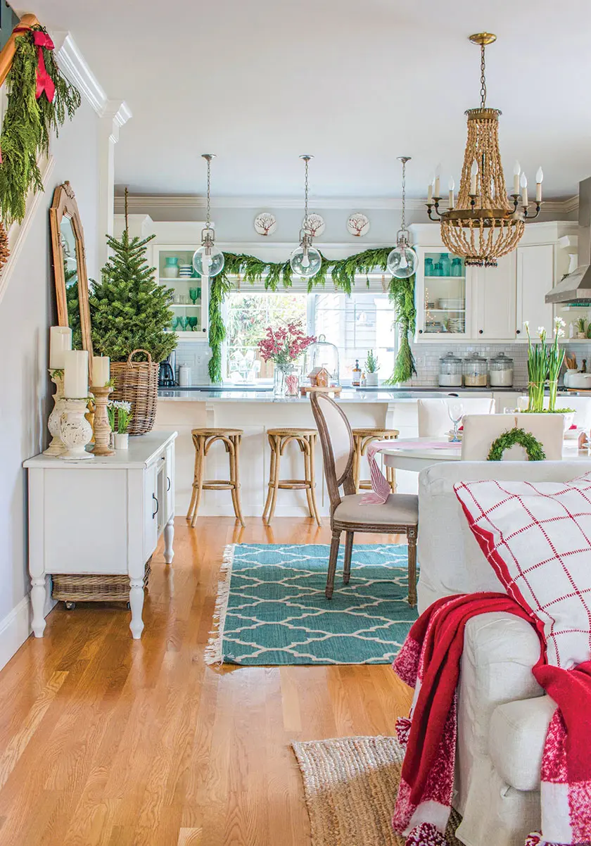 cedar garlands and red pillows and throws in holiday kitchen
