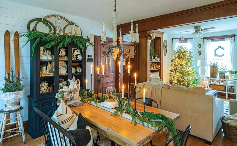 dining and living room with candle light and fresh greenery