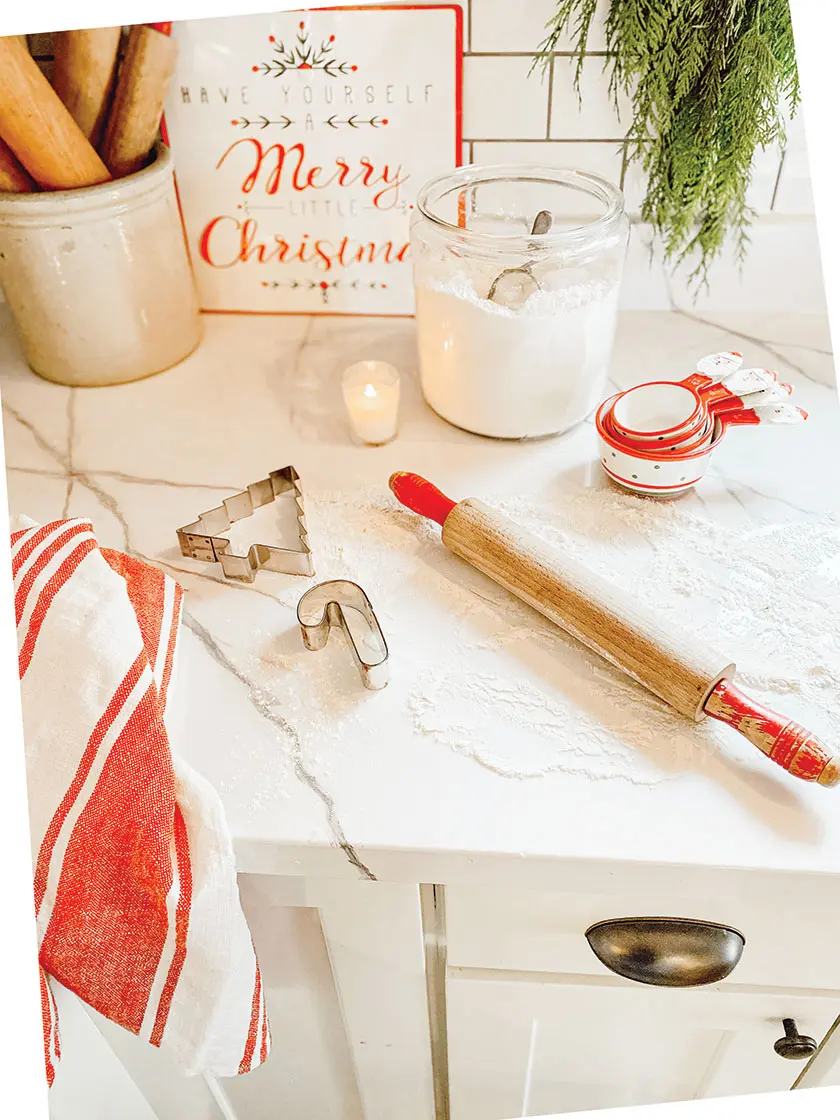 vintage rolling pins with red handles and Christmas cup measures