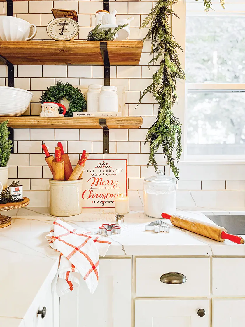 cozy Christmas kitchen with vintage rolling pins and red and white Merry Christmas sign
