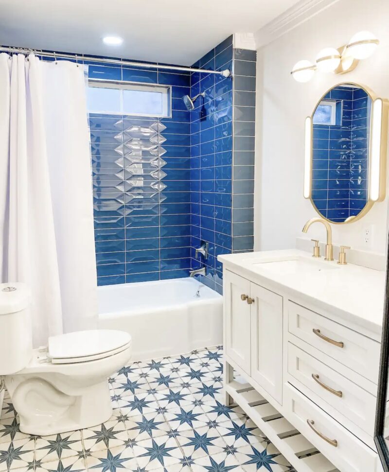 Cottage on Fort with mosaic tile and blue shower tile