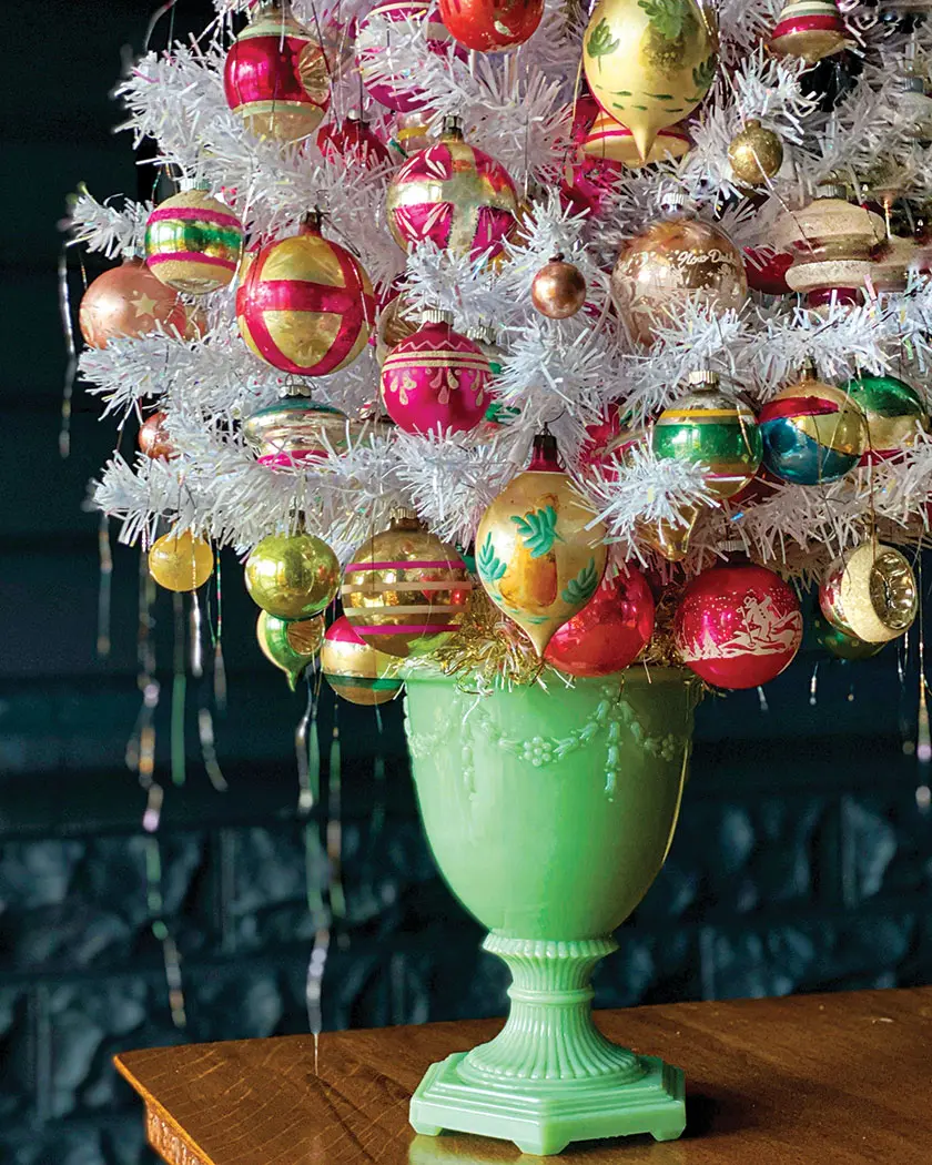 jadeite vase holds white faux tree and vintage ornaments