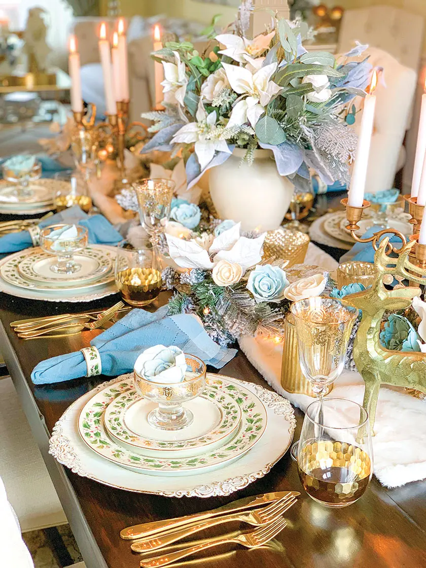 blue and white roses and white and blue flower arrangement in Christmas tablescape