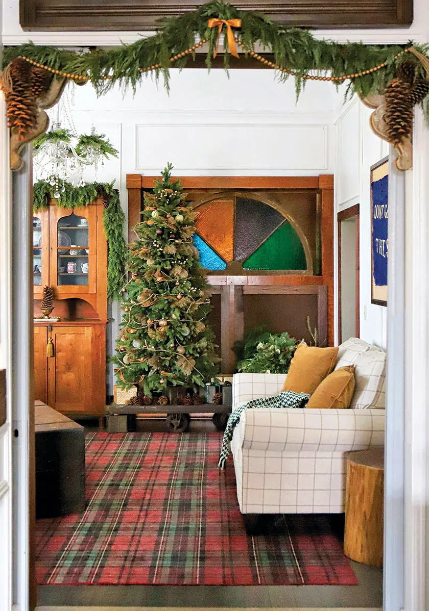 living room with garlands Christmas tree and stained glass