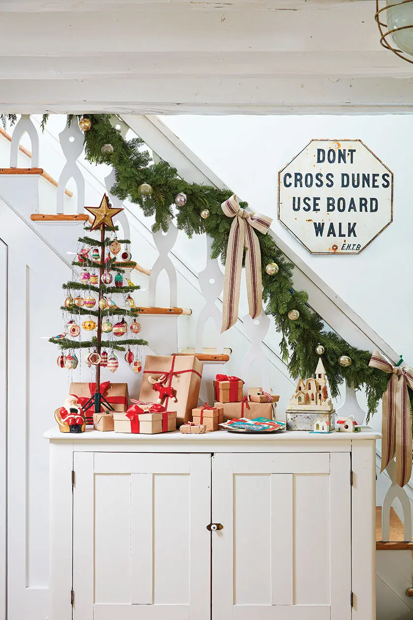 stairway with natural garland and mini tree with vintage ornaments