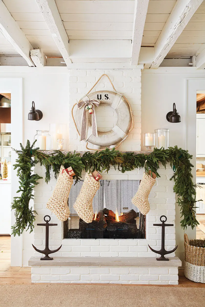 fresh greenery on mantel and vintage lifesaver with Christmasbow