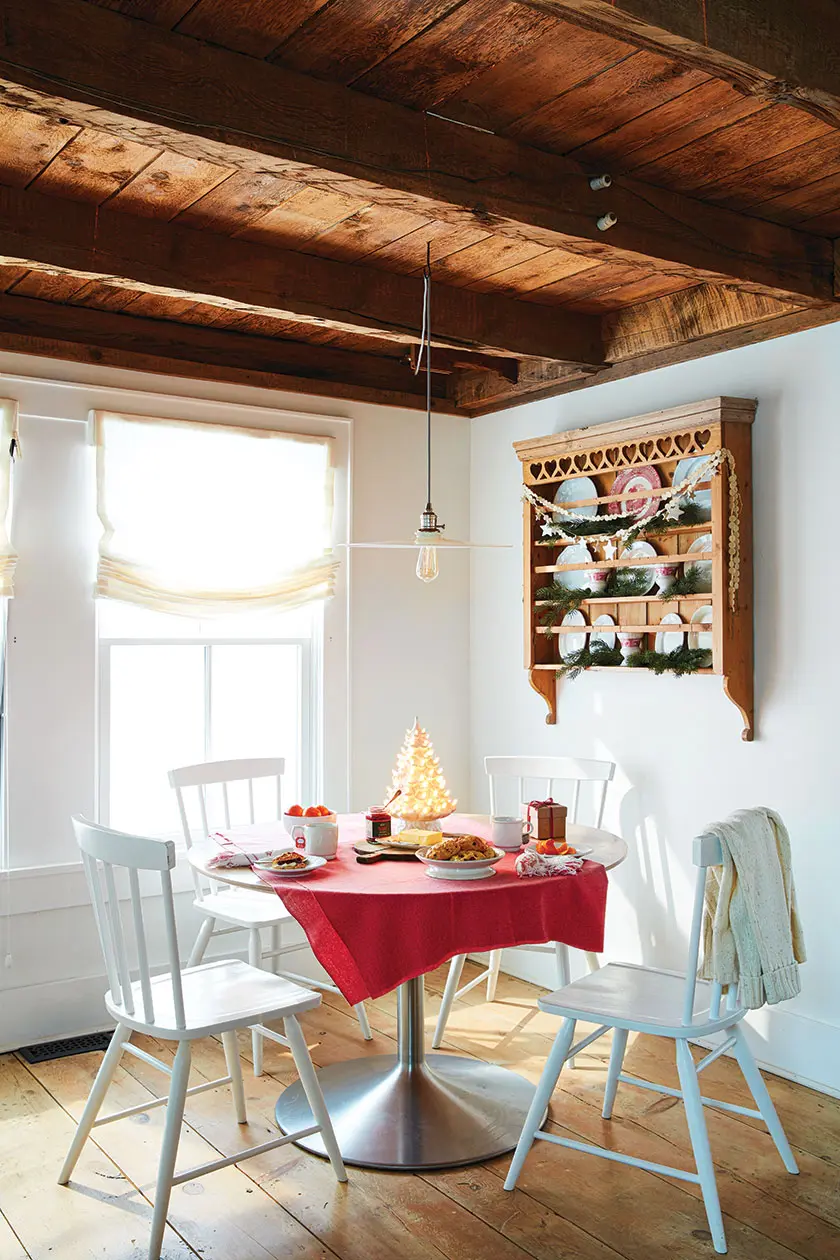 white ceramic light up tree in breakfast nook of Christmas cottage