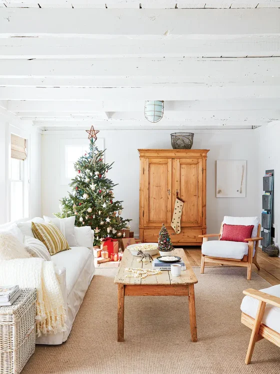 Christmas tree and small potted tree in Christmas cottage with natural and vintage decor