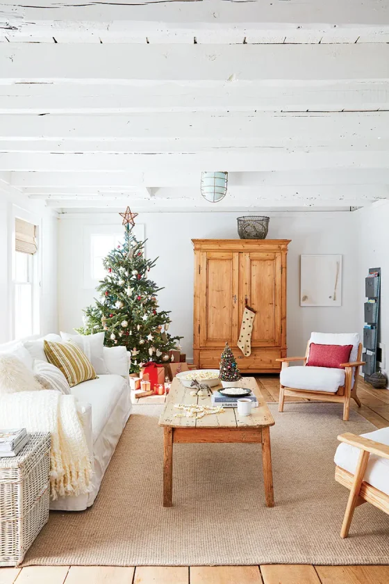 Christmas tree and small potted tree in Christmas cottage with natural and vintage decor