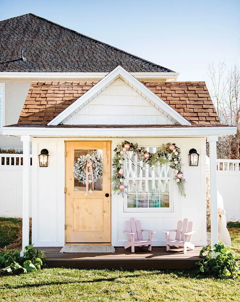 kids playhouse with Christmas wreath and garland