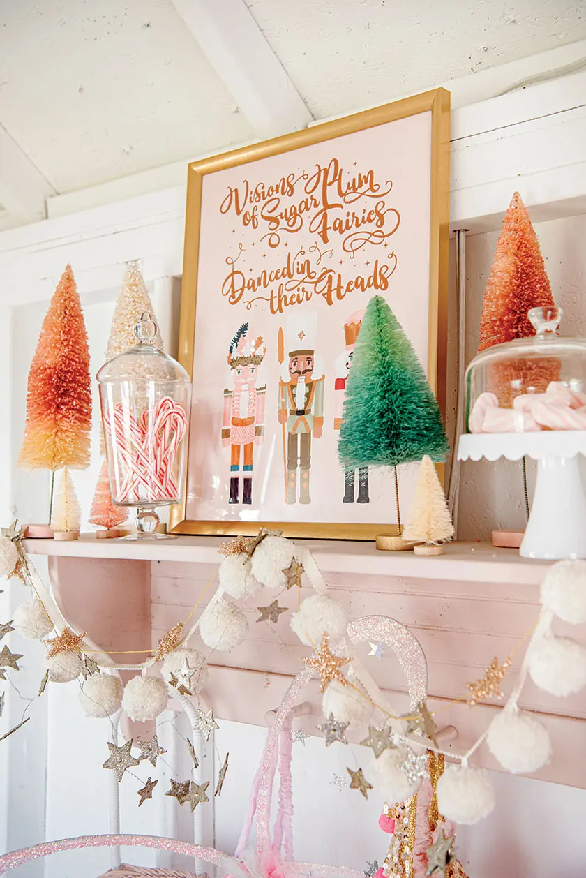 bottle brush trees, Nutcracker print and pompom garland in home with Christmas whimsy