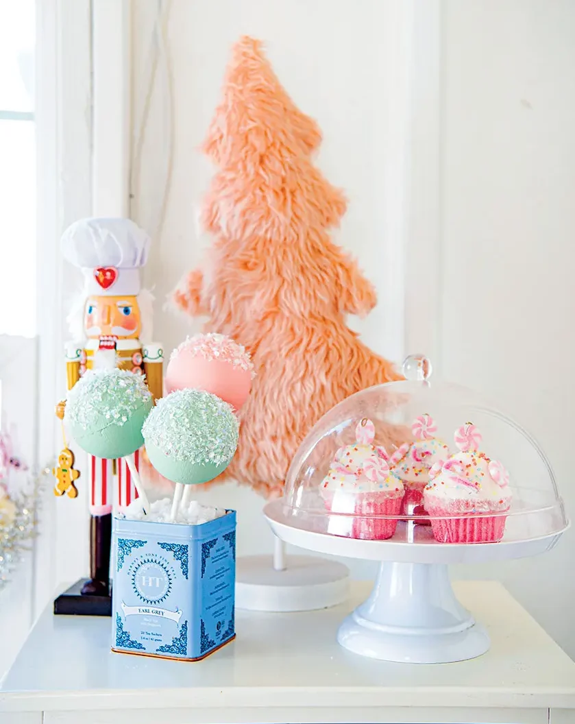 Christmas whimsy play area decor with cupcake and cake pops and pink mini tree