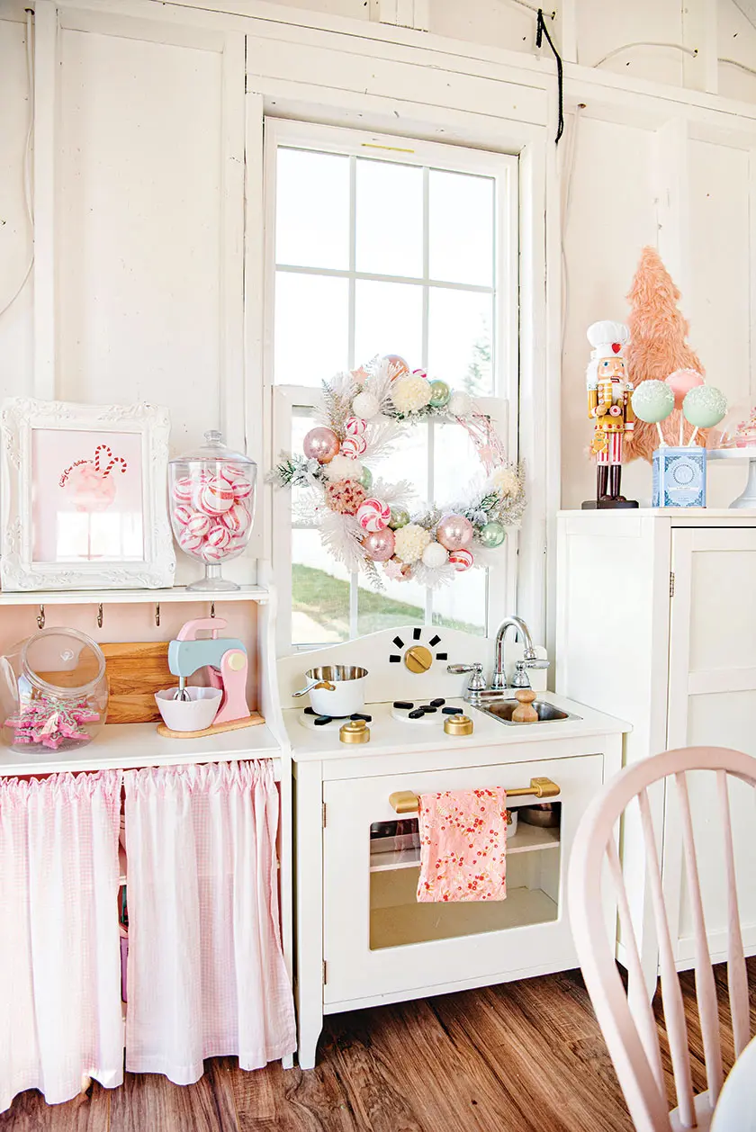play kitchen with white and pink wreath