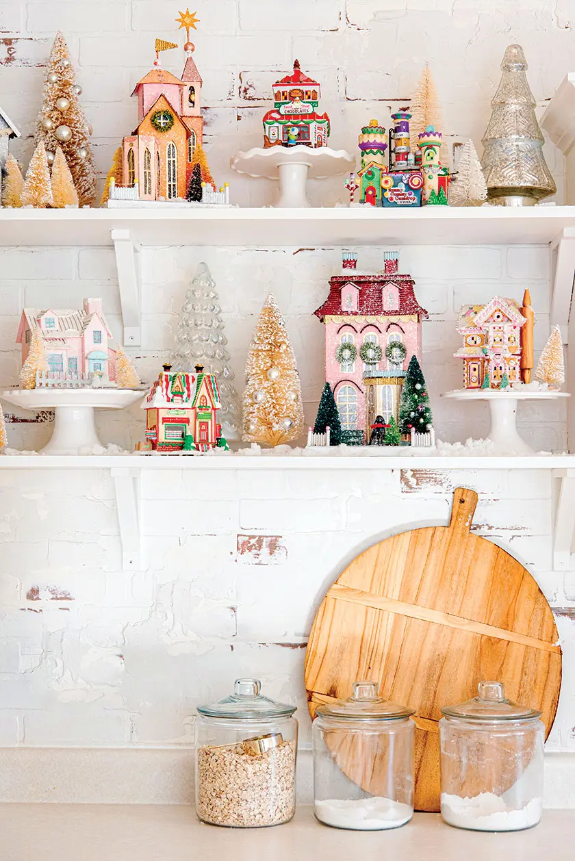 Christmas village in exposed shelves in pantry