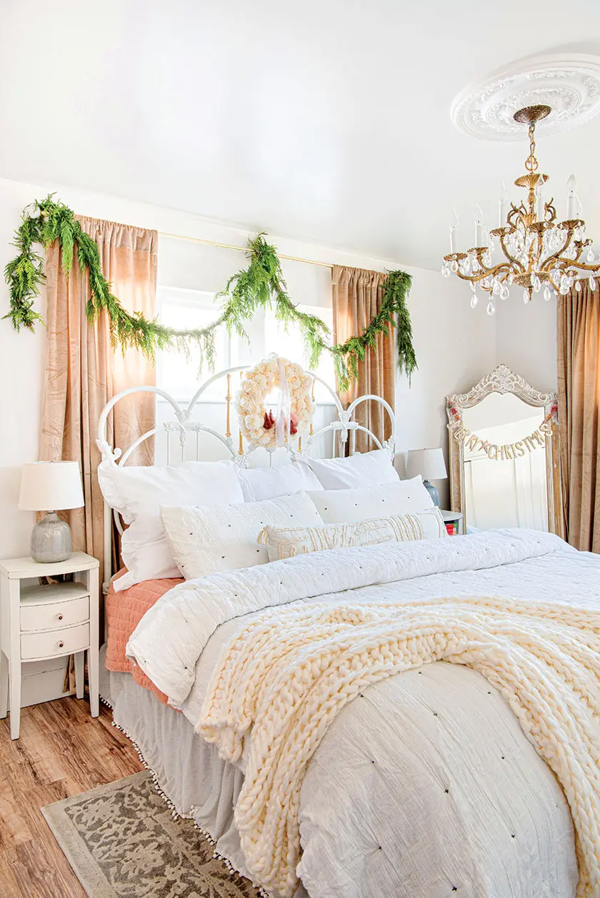 cedar garlands and white wreath decorating the primary bedroom