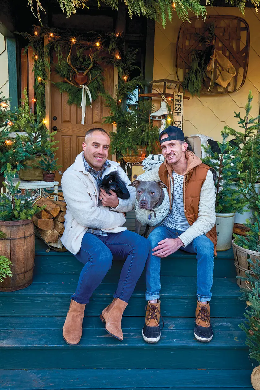 homeowners Greg and Dave with their pets outside their cozy holiday home