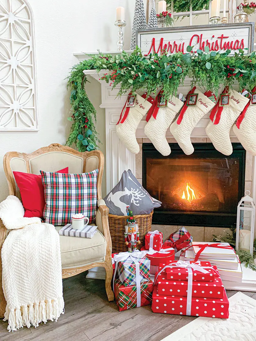 fireplace with reindeer throw pillows and wrapped presents