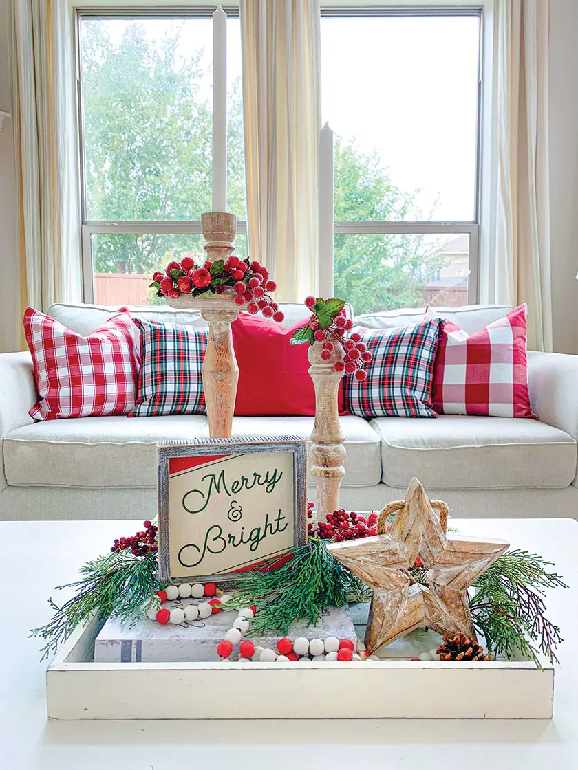 red plaid throw pillows tapered candles and fresh greenery in living room