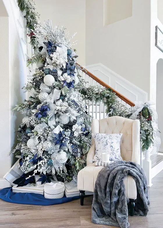 blue and white tree in foyer of Nissa-Lynn's magical holiday home