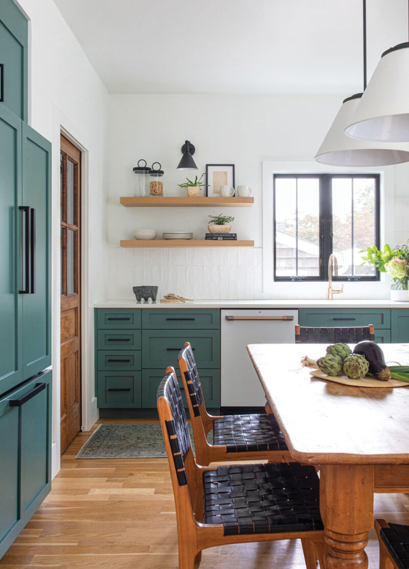 teal kitchen cabinetry and modern webbed dining chairs in sophisticated beach bungalow