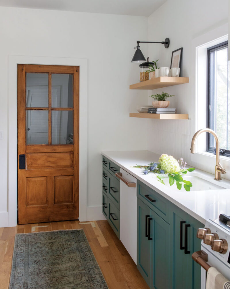 pantry door and teal cabinetry in beach bungalow kitchen