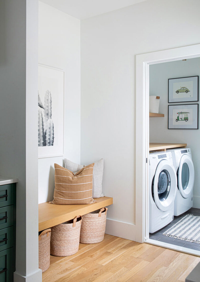 woven baskets and black and white art prints in laundry area