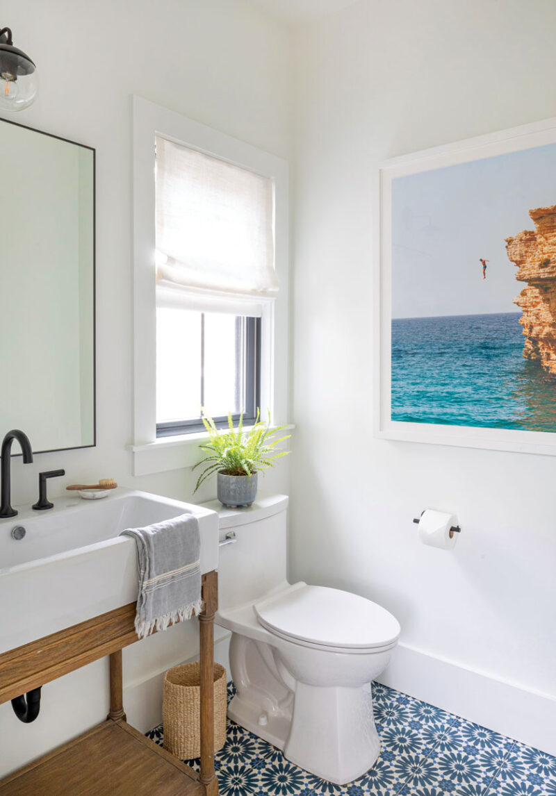 bathroom with blue mosaic tile and cliff diver photo
