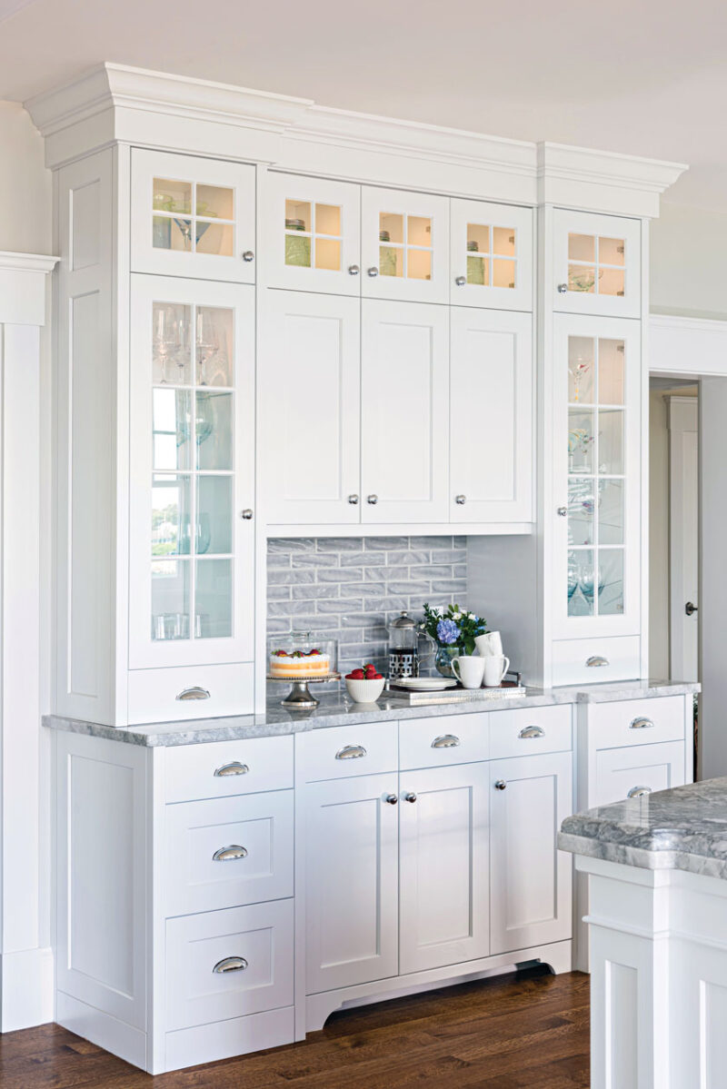 white shelves surrounding breakfast bar in Cape Cod cottage