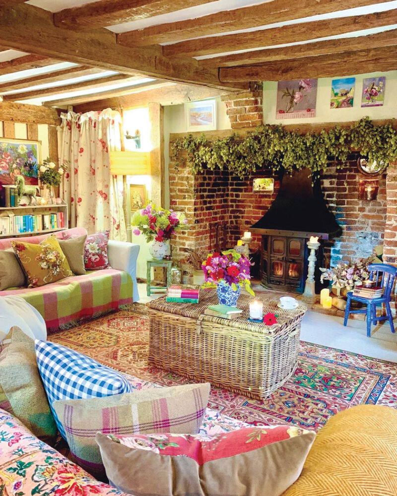 brick fireplace and wood beam in historic English countryside cottage