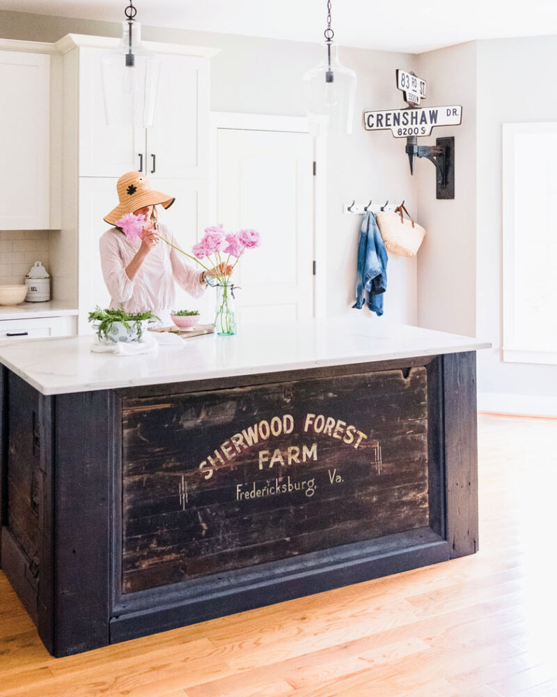 flower arrangement in kitchen with vintage street signs as wall decor