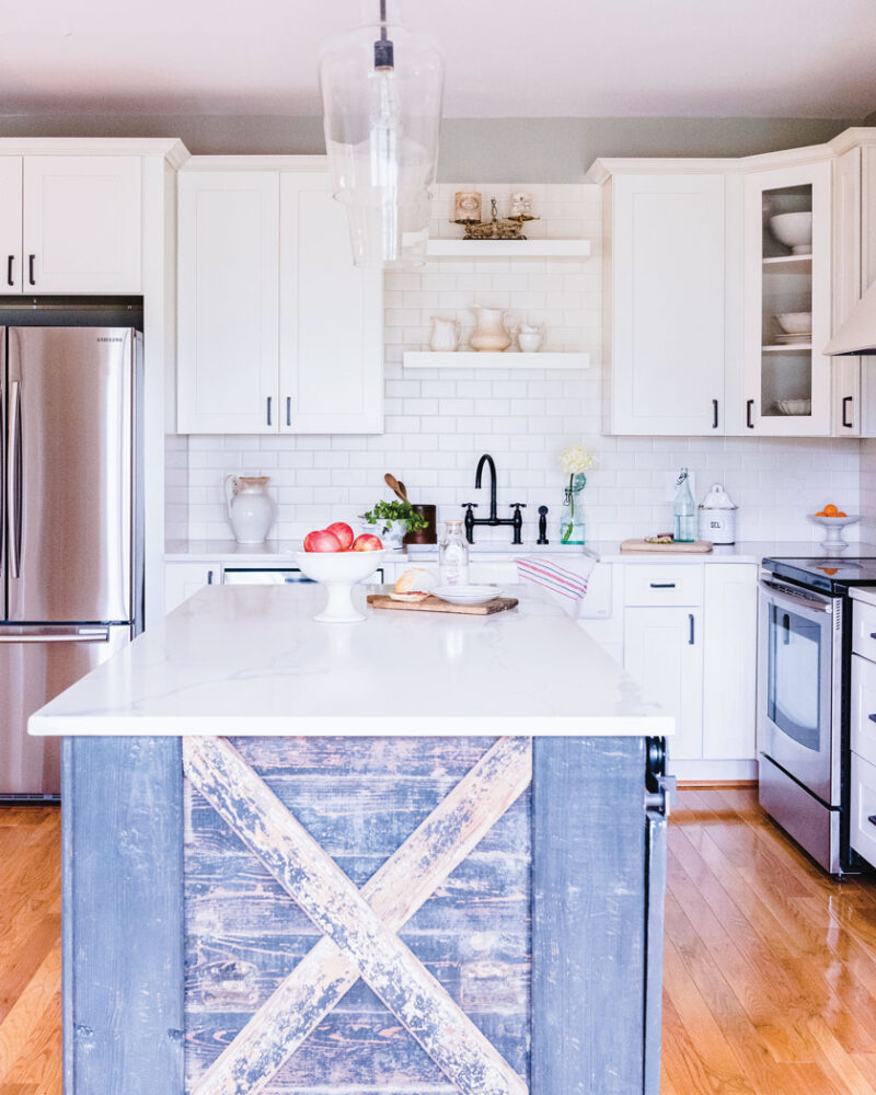 cottage kitchen with weathered wood acent on island and flower arrangement