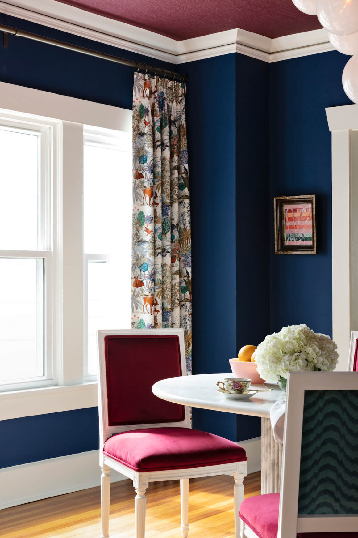 dining room with navy blue walls and plum colored ceiling