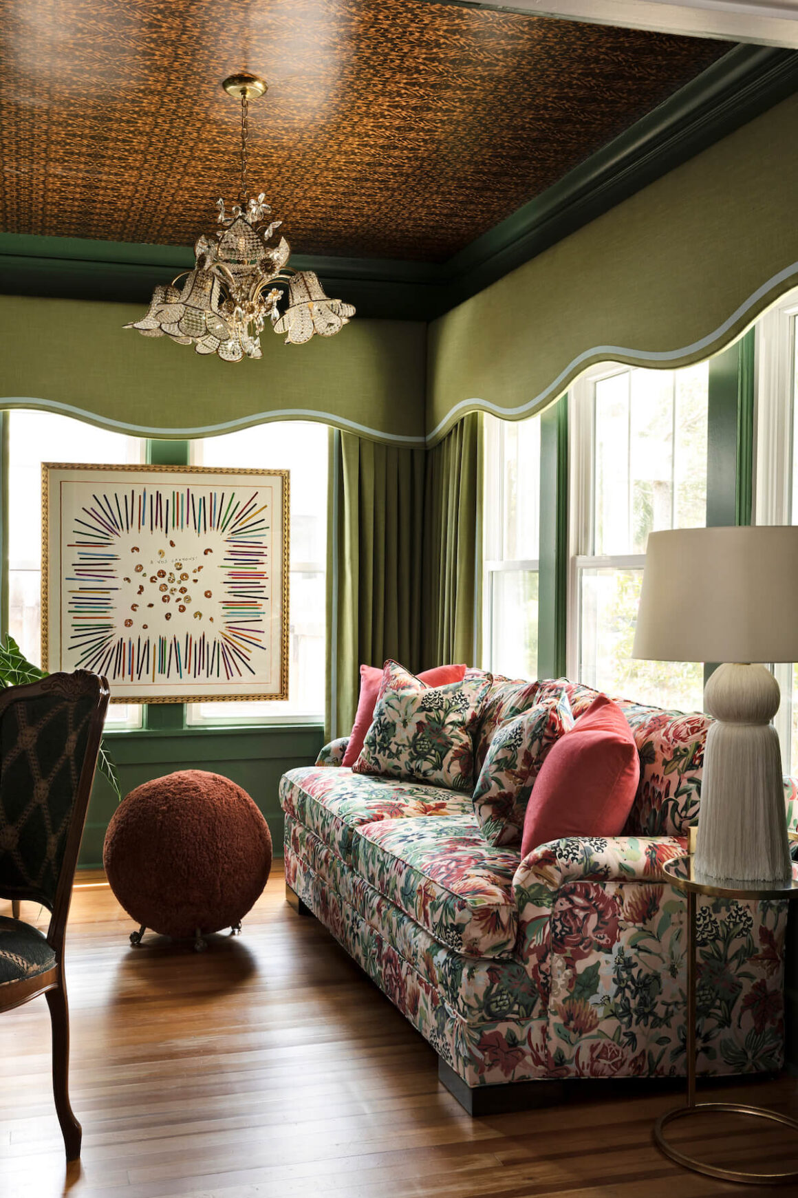 traditional floral chandelier and floral sofa in green study