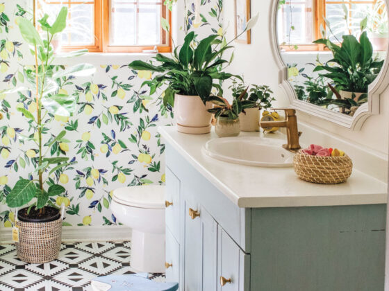 lemon botanical wallpaper and geometric floor tile pattern in updated bathroom