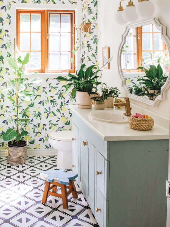 lemon botanical wallpaper and geometric floor tile pattern in updated bathroom