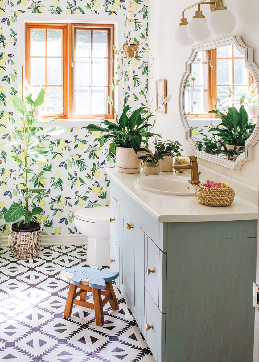 lemon botanical wallpaper and geometric floor tile pattern in updated bathroom