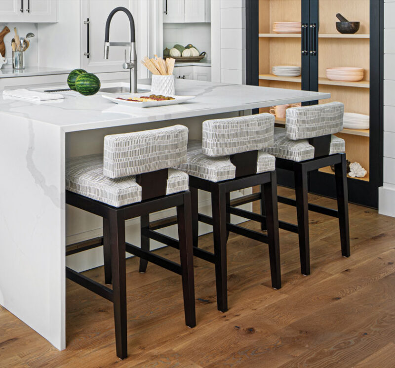kitchen with marble island and neutral barstools