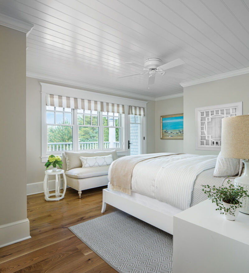 guest bedroom with large picture windows and sand inspired color palette