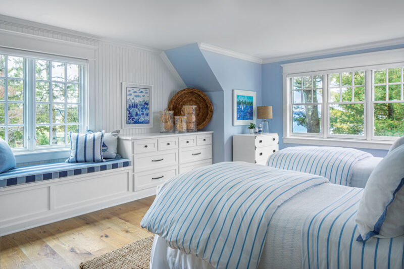 window bench and blue and white theme in cottage bedroom