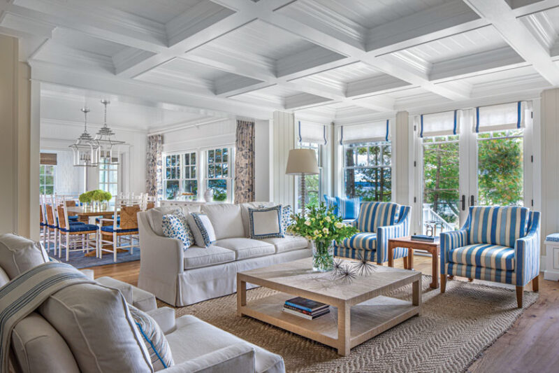 sitting and dining room with coffered ceiling and lakeside view