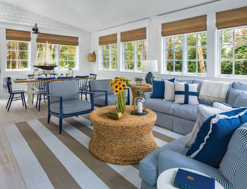 enclosed porch with dining table and seating area