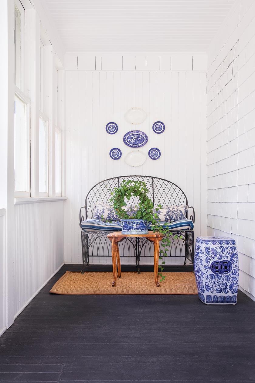 sunroom with vintage pie plates in small cottage