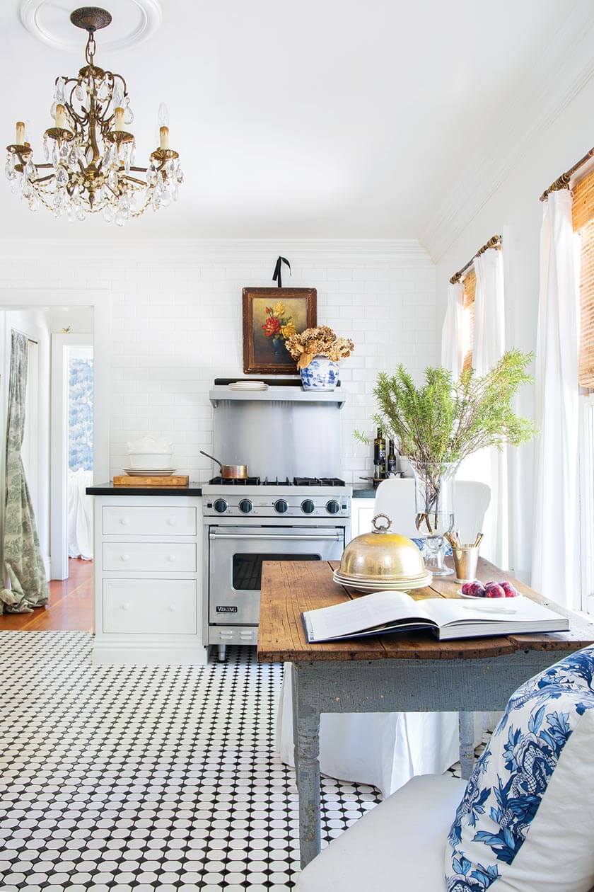 chandelier in small cottage kitchen styled in white and blue