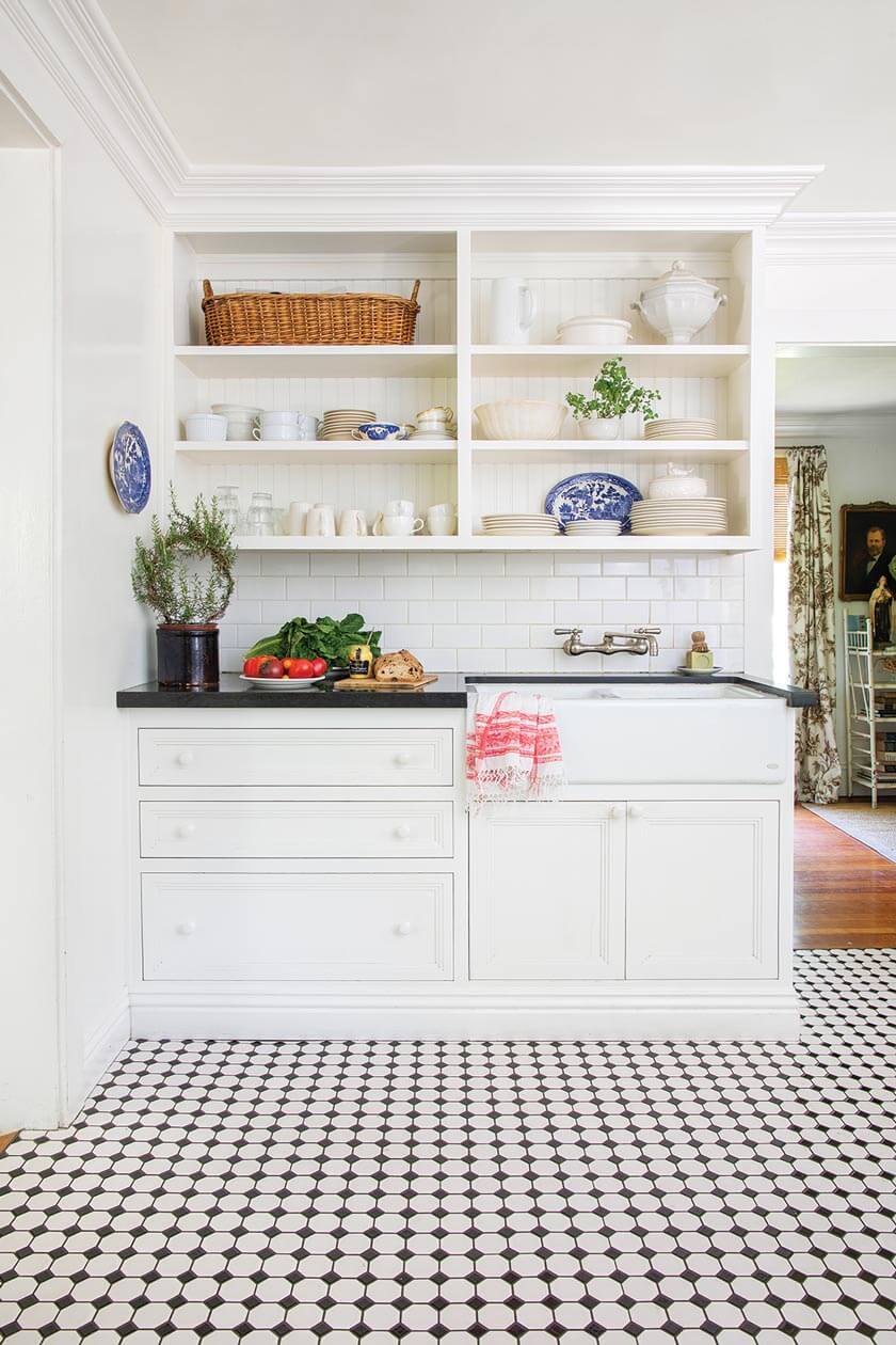 black and white kitchen with farmhouse sink and subway tile