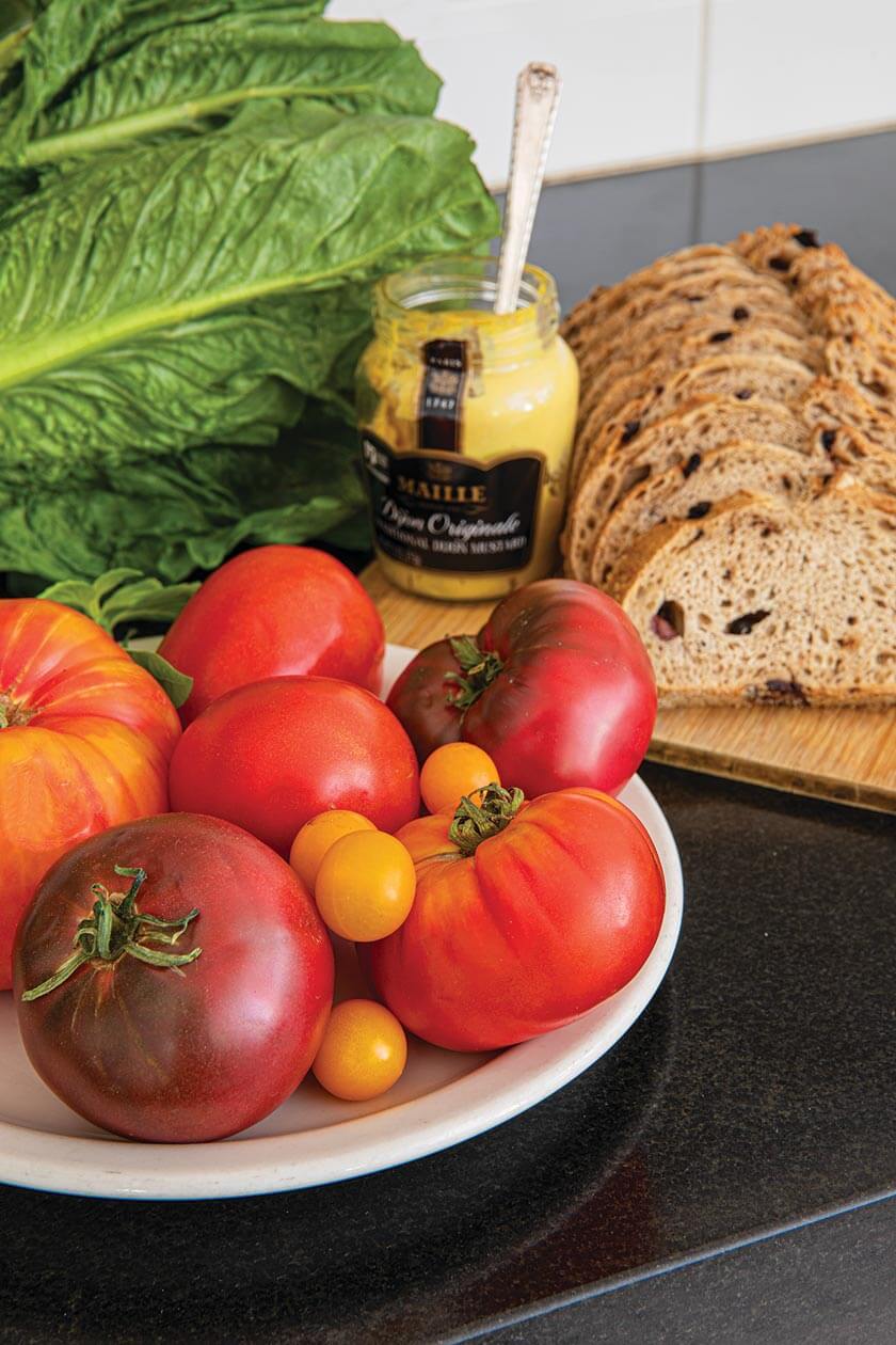 tomatoes lettuce and bread on kitchen counter in cottage