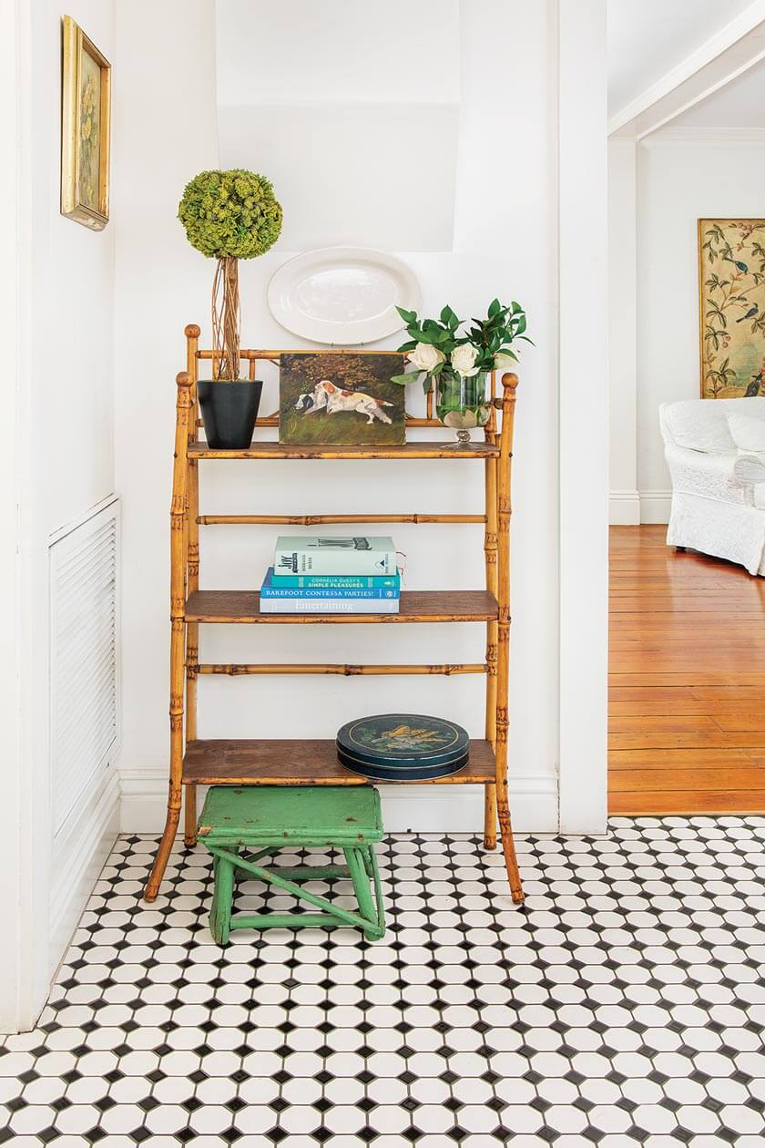 black and white tile floor in small cottage styled with vintage pieces