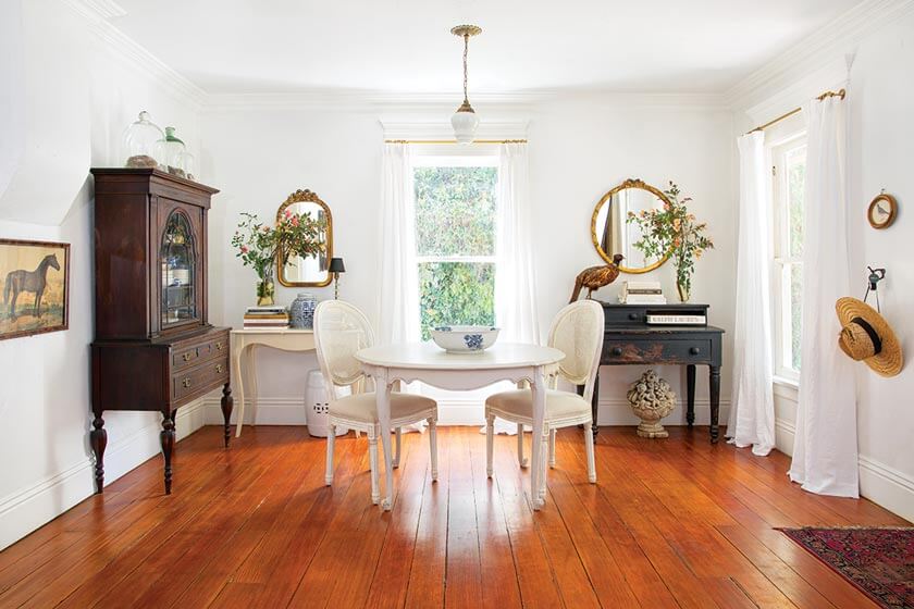 small cottage styling with white and antique furniture and white drapery